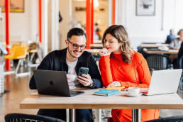 Sophie and Dan looking at a phone